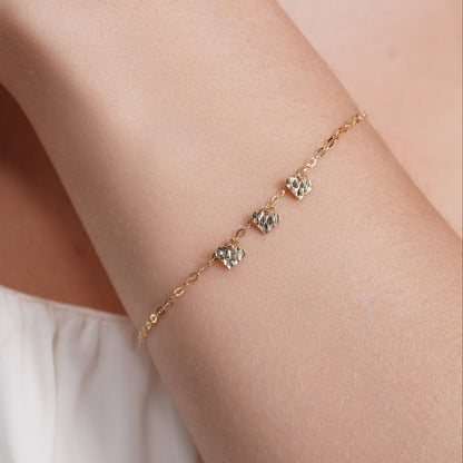 14KB0012. - 14 Karat Yellow Gold Three Diamond Cut Heart Charm Adjustable Bracelet