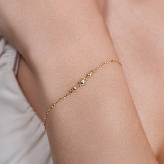 14KB0018. - 14 Karat Yellow Gold Three Hearts Charm Adjustable Bracelet