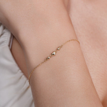 14KB0018. - 14 Karat Yellow Gold Three Hearts Charm Adjustable Bracelet